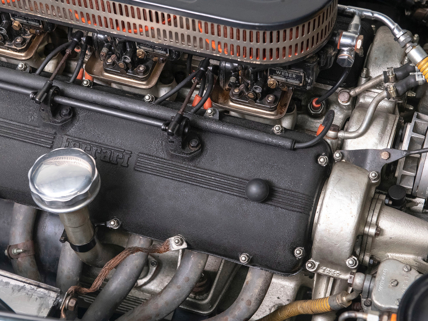 This is an original Ferrari 250 GT engine used in various classic Ferrari models. It shows the Weber caburettors aswell including some other engine components.