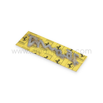 NOS Ferrari Dino GT script badge in original package for Ferrari Dino 246 GT