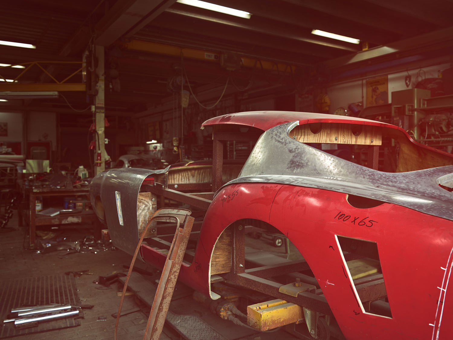 This is a photo taken in the workshop of Hietbrink Coachbuilding. It shows a Ferrari 250 SWB 1961 body jig. There are some aluminium sheets on it for test fitting.